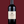 Laden Sie das Bild in den Galerie-Viewer, Eine Flasche La Bastille Rouge auf dunkelrotem Hintergrund. Die Färbung der Flasche ist wegen der dunklen Farbe des Weins nicht zu erkennen, das Etikett ist weiß. Darauf steht mit schwarzer Schrift: &quot;La Bastille&quot;. Darunter in dunkelroter Schrift: &quot;Carignan - Merlot&quot;

